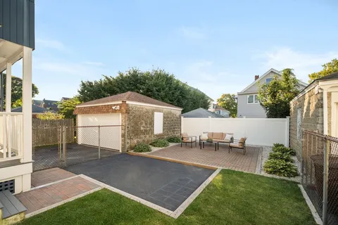 a view of a backyard with sitting area