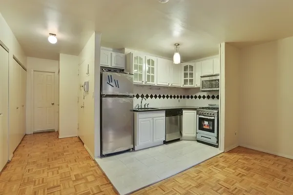 a kitchen with stainless steel appliances a refrigerator and a stove top oven
