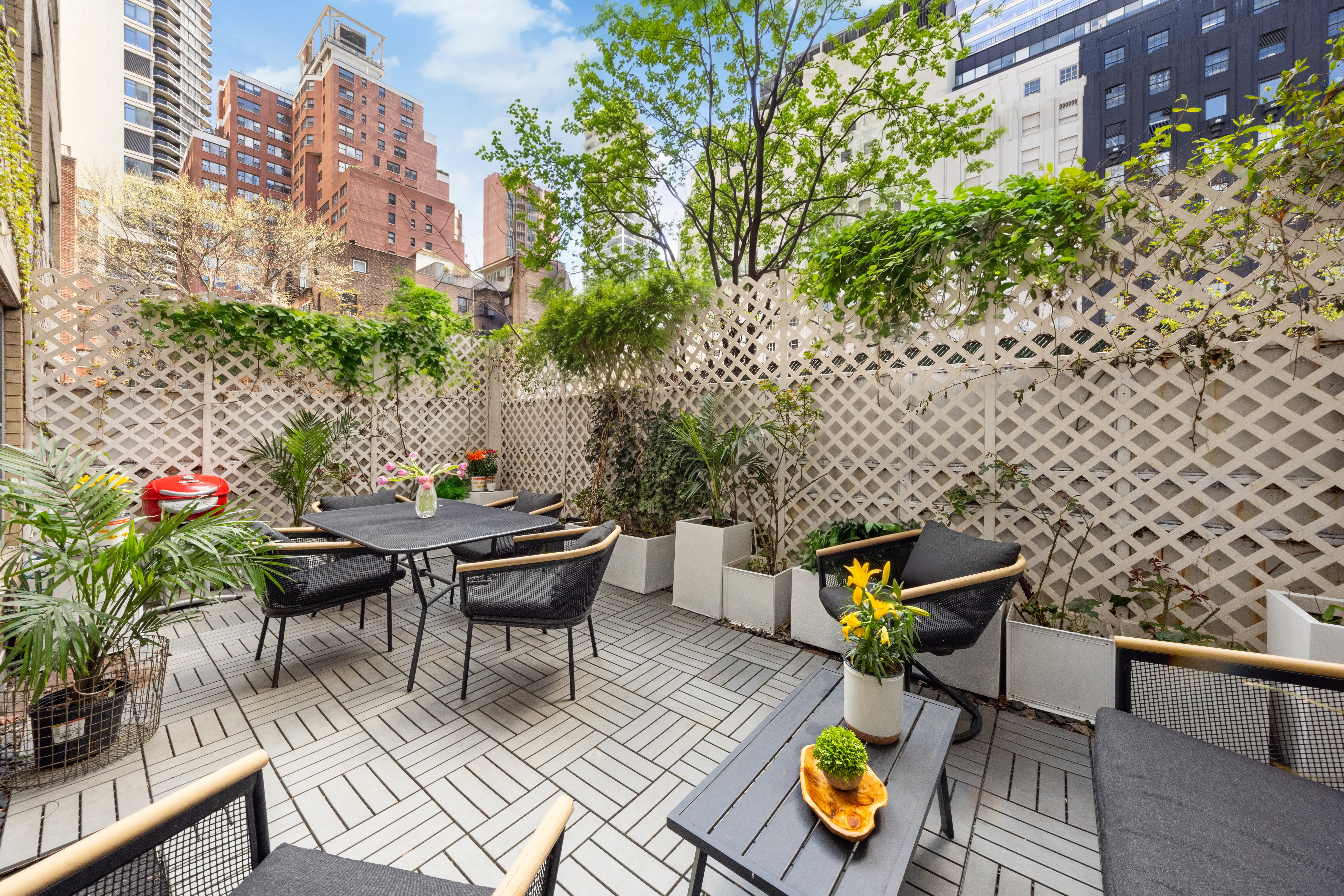 150 East 61st Street, Unit 2A Manhattan, NY 10065 - Photo 4 of 9 a view of a chairs and table in a patio