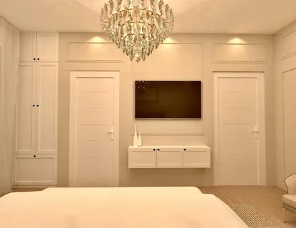 a bedroom with a bed and a flat screen tv