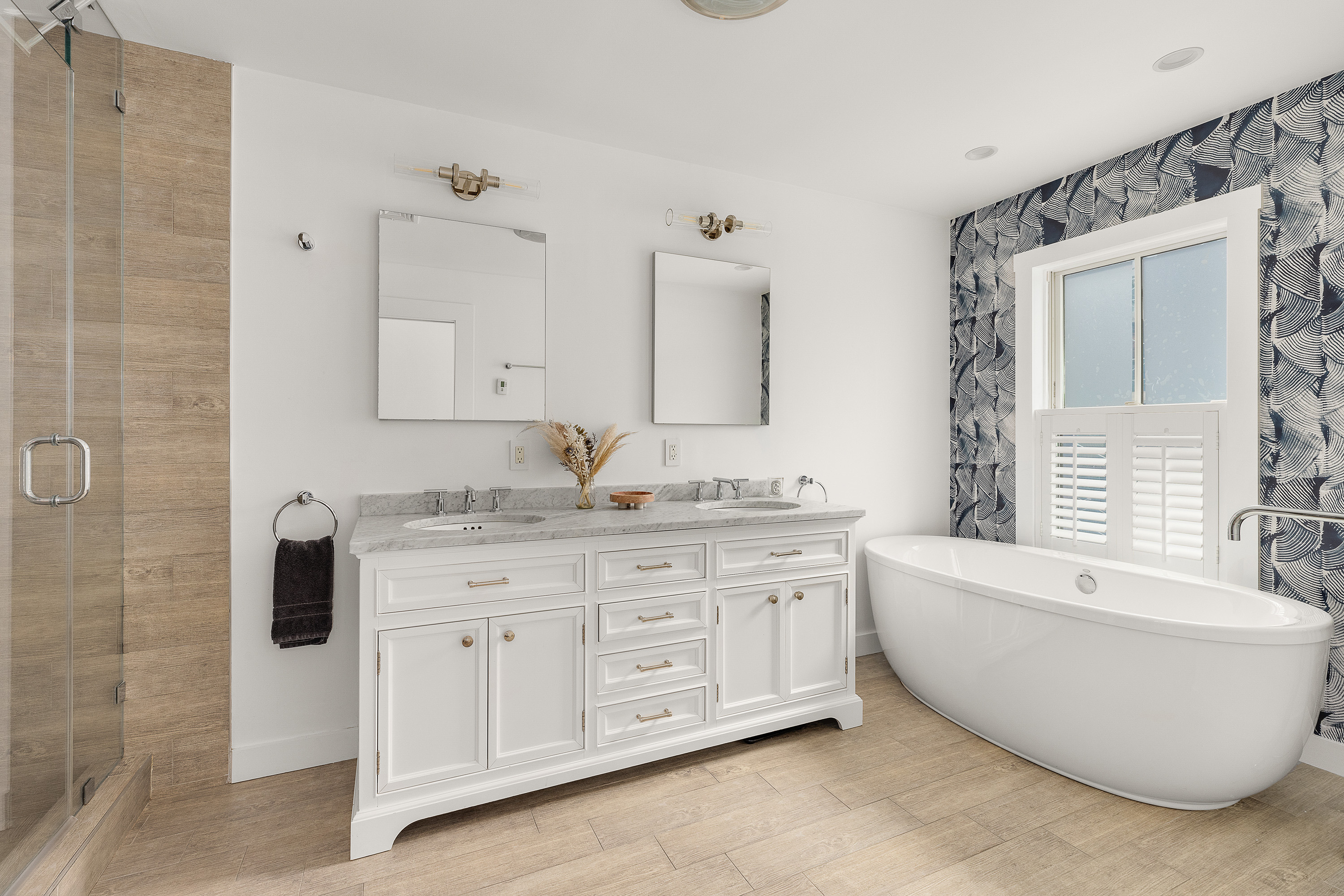 330 Bond Street Brooklyn, NY 11231 - Photo 9 of 18 a spacious bathroom with a double vanity sink a mirror and a bathtub