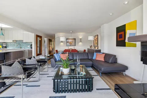 a living room with furniture and wooden floor