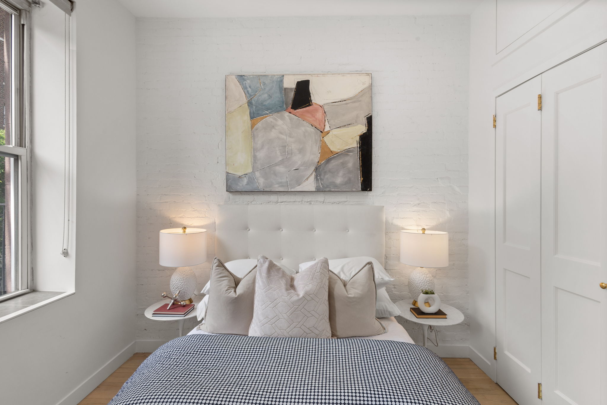 237 East 12th Street, Unit 2A Manhattan, NY 10003 - Photo 6 of 16 a bedroom with a bed and window