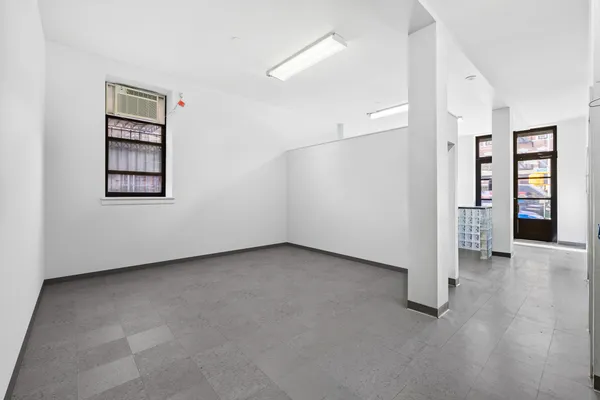 an empty room with closet and windows