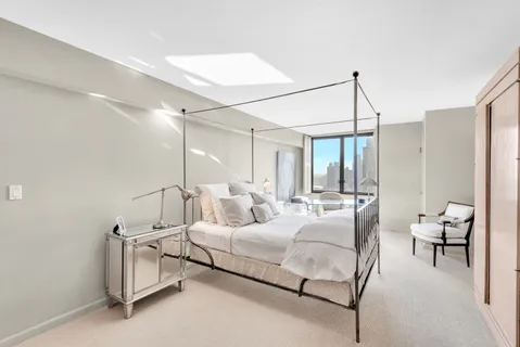 a bedroom with furniture and a chandelier