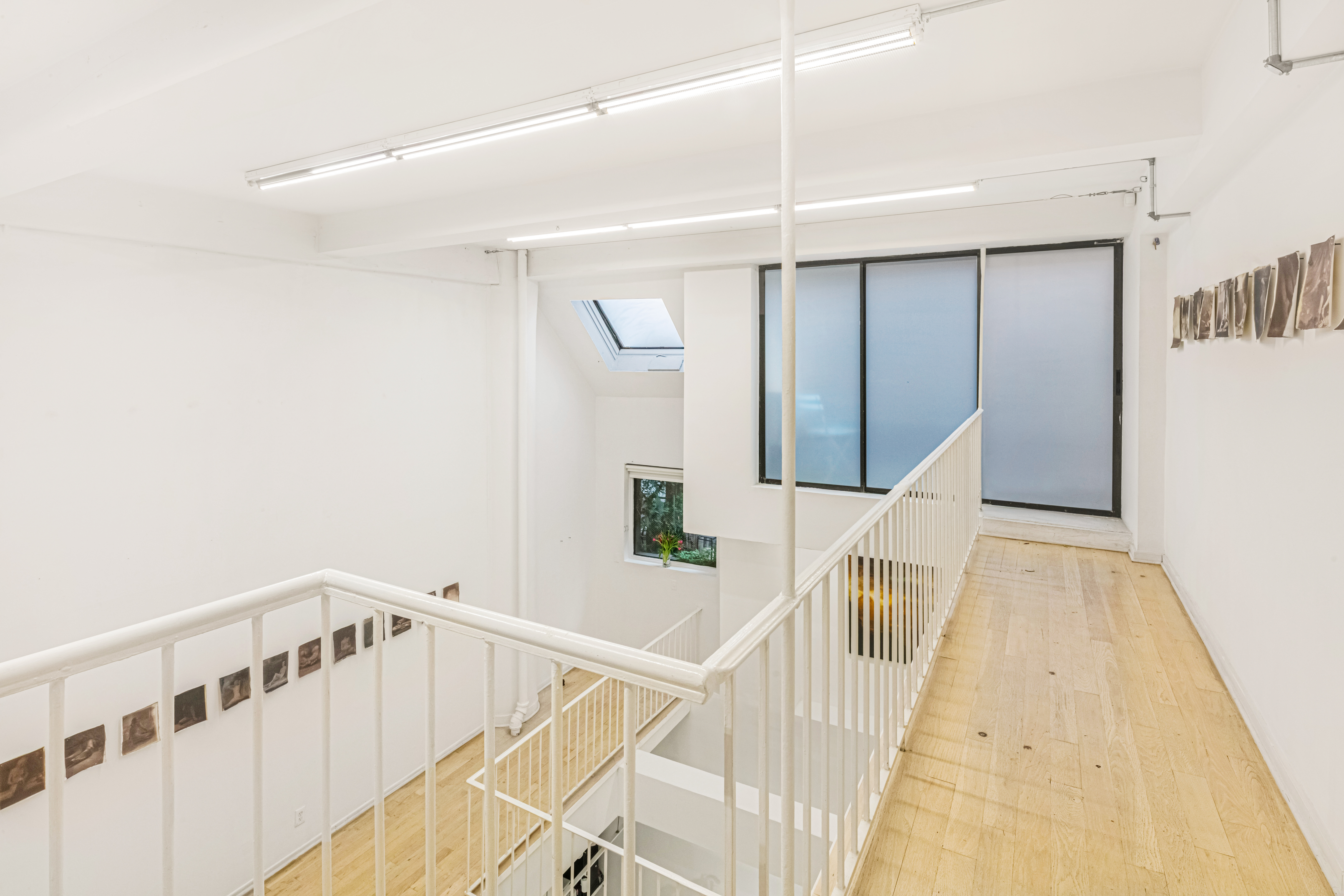 251 West 19th Street, Unit 1G Manhattan, NY 10011 - Photo 19 of 31 a view of a hallway with white walls