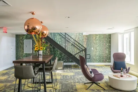 a living room with furniture a lamp and large window