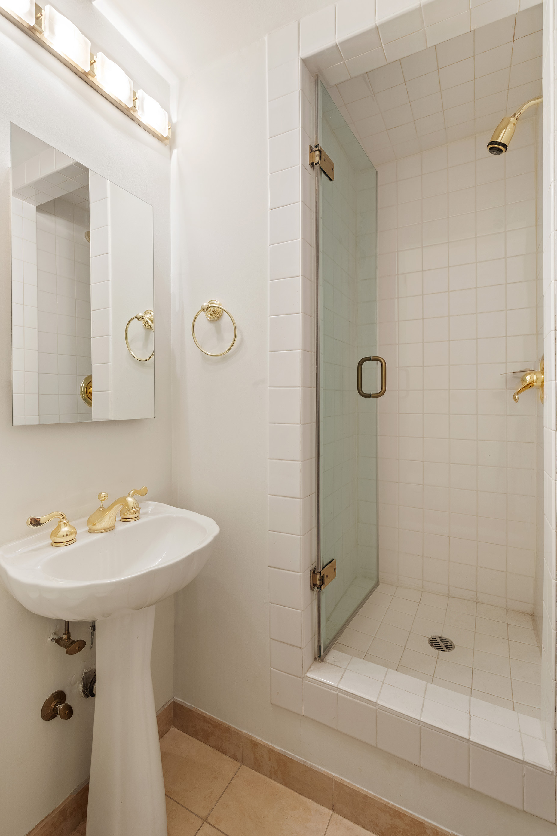 12 Beekman Place, Unit 7/8B Manhattan, NY 10022 - Photo 11 of 17 a bathroom with a sink a toilet and shower