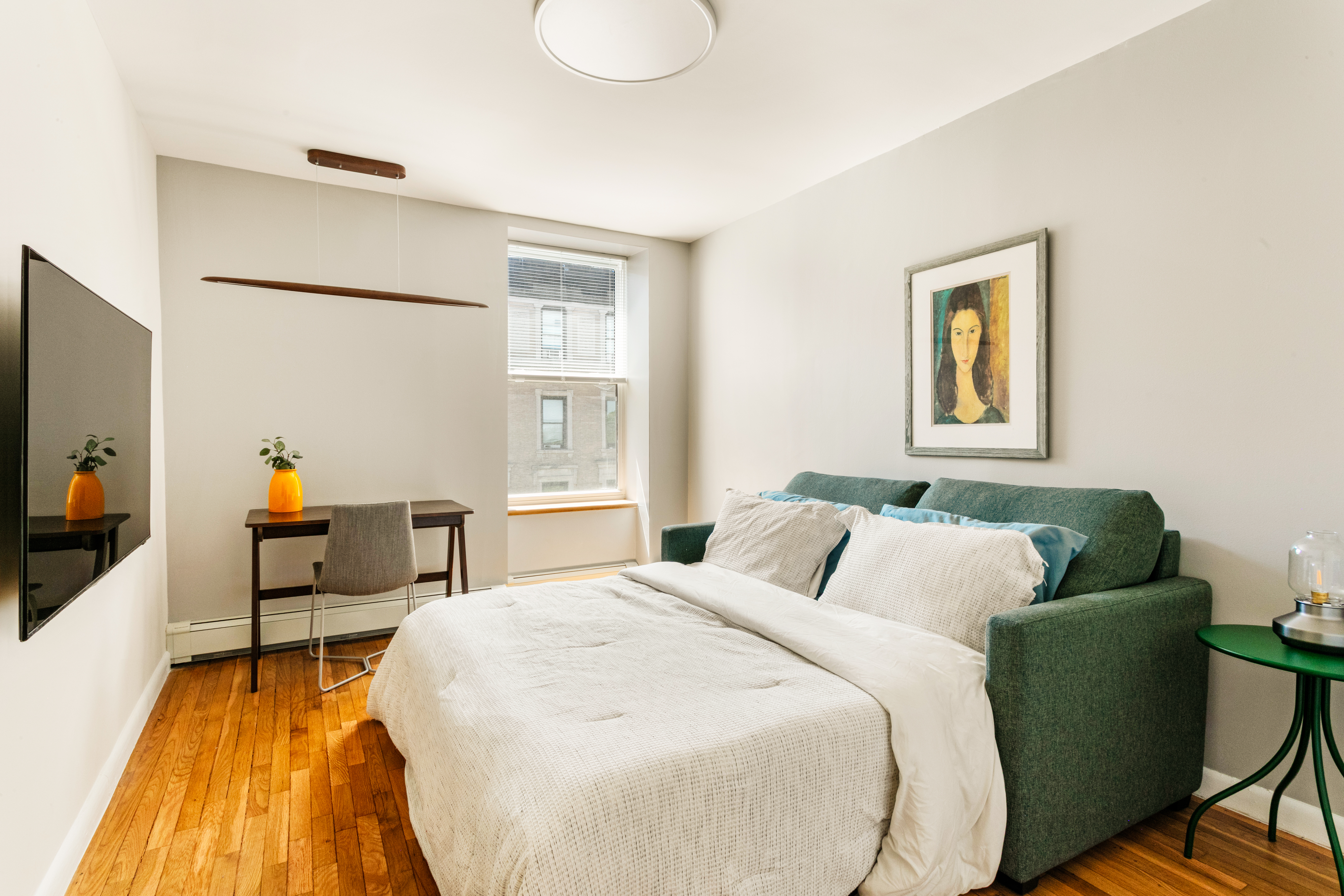 317 West 95th Street, Unit 6F Manhattan, NY 10025 - Photo 8 of 11 a bedroom with a bed and wooden floor