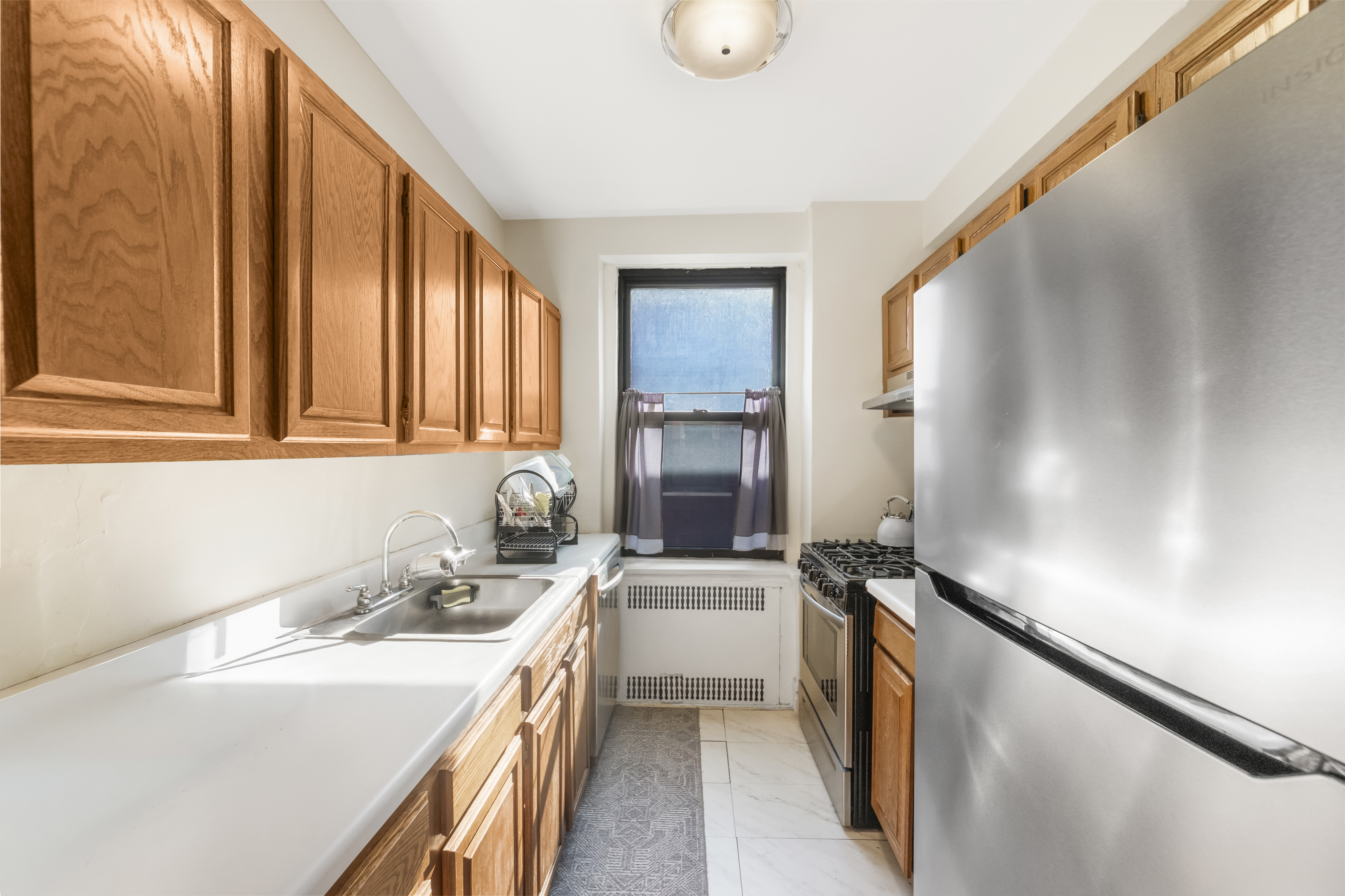 3220 Avenue H, Unit 6N Brooklyn, NY 11210 - Photo 4 of 9 a kitchen with a sink stove and refrigerator