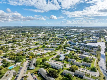 a view of a city with lots of residential buildings ocean and mountain view in back