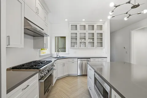 a kitchen with a stove and a sink