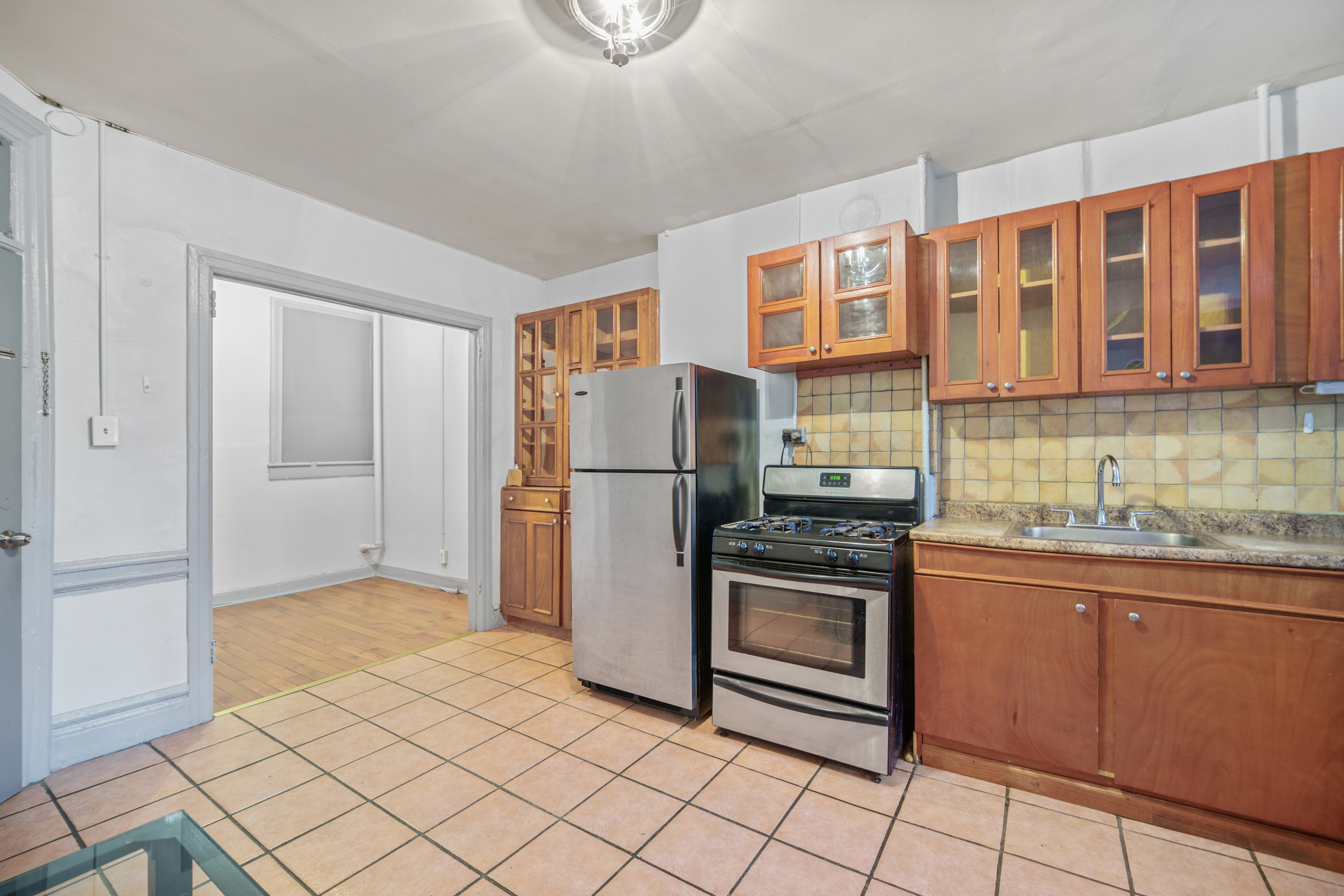 1663 1st Avenue, Unit 2S Manhattan, NY 10028 - Photo 5 of 6 a kitchen with stainless steel appliances granite countertop a refrigerator and a stove top oven