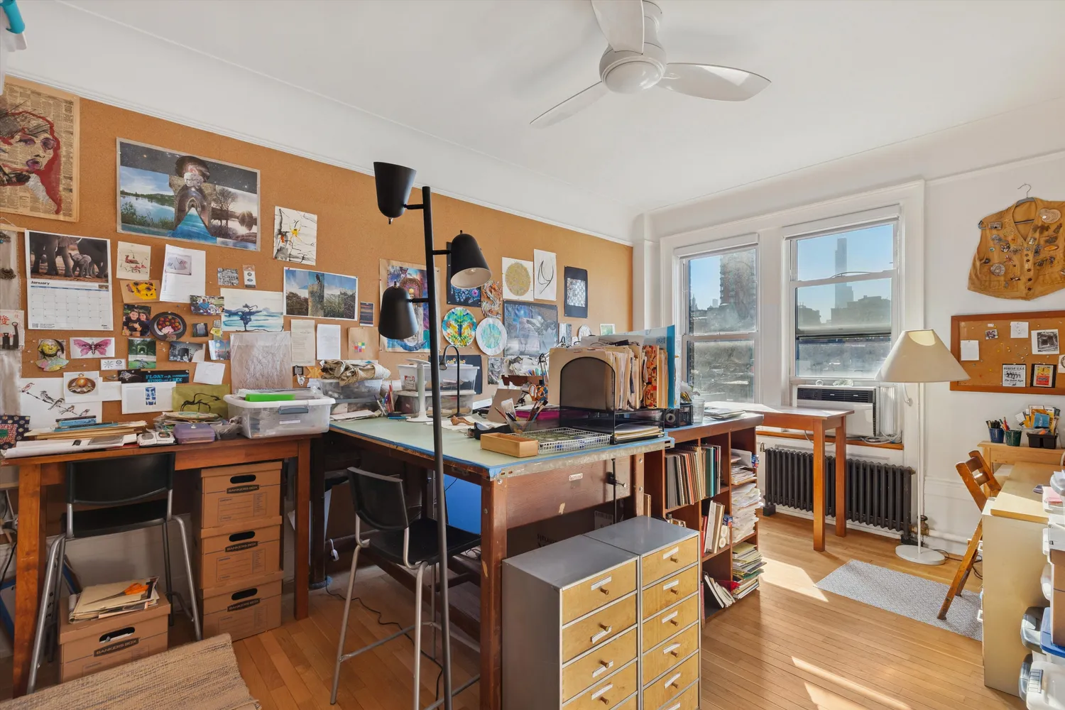 a view of a workspace with furniture and a window