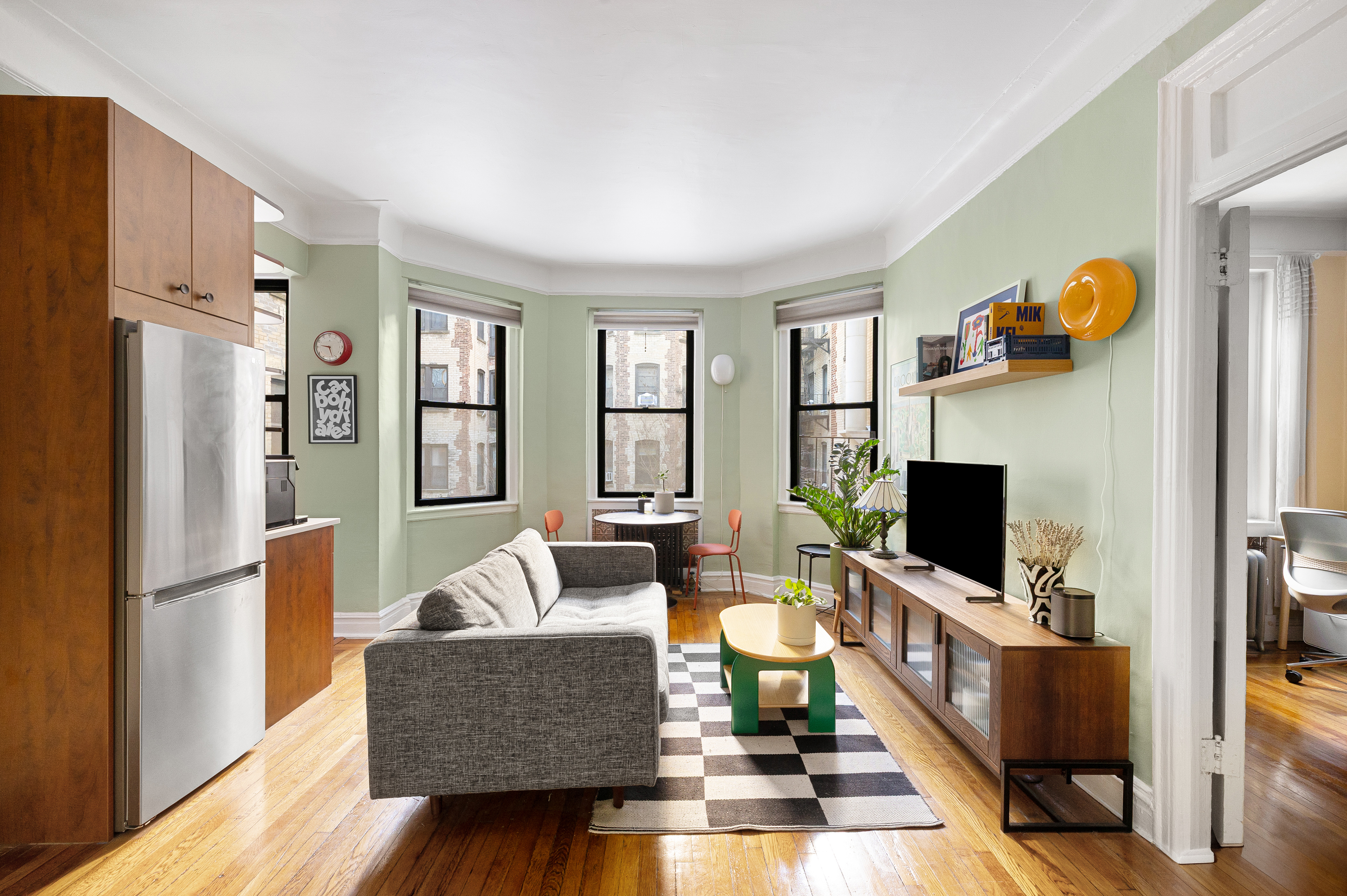 78 8th Avenue, Unit 2K Brooklyn, NY 11215 - Photo 1 of 10 a living room with furniture and a flat screen tv