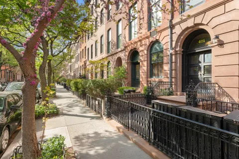a view of a brick house with many windows