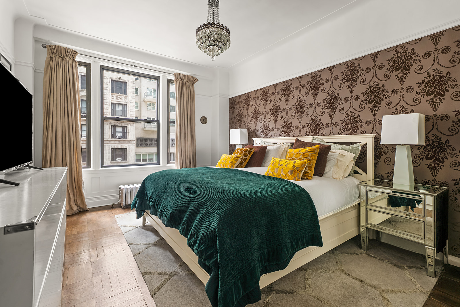 200 West 54th Street, Unit 10D Manhattan, NY 10019 - Photo 5 of 8 a bedroom with a bed and a flat tv screen on dresser