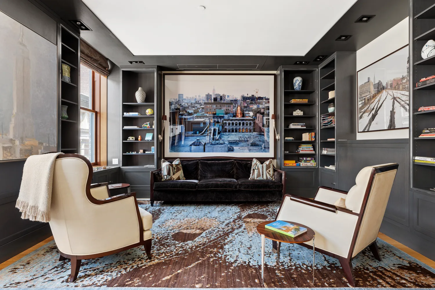 a living room with furniture and a floor to ceiling window