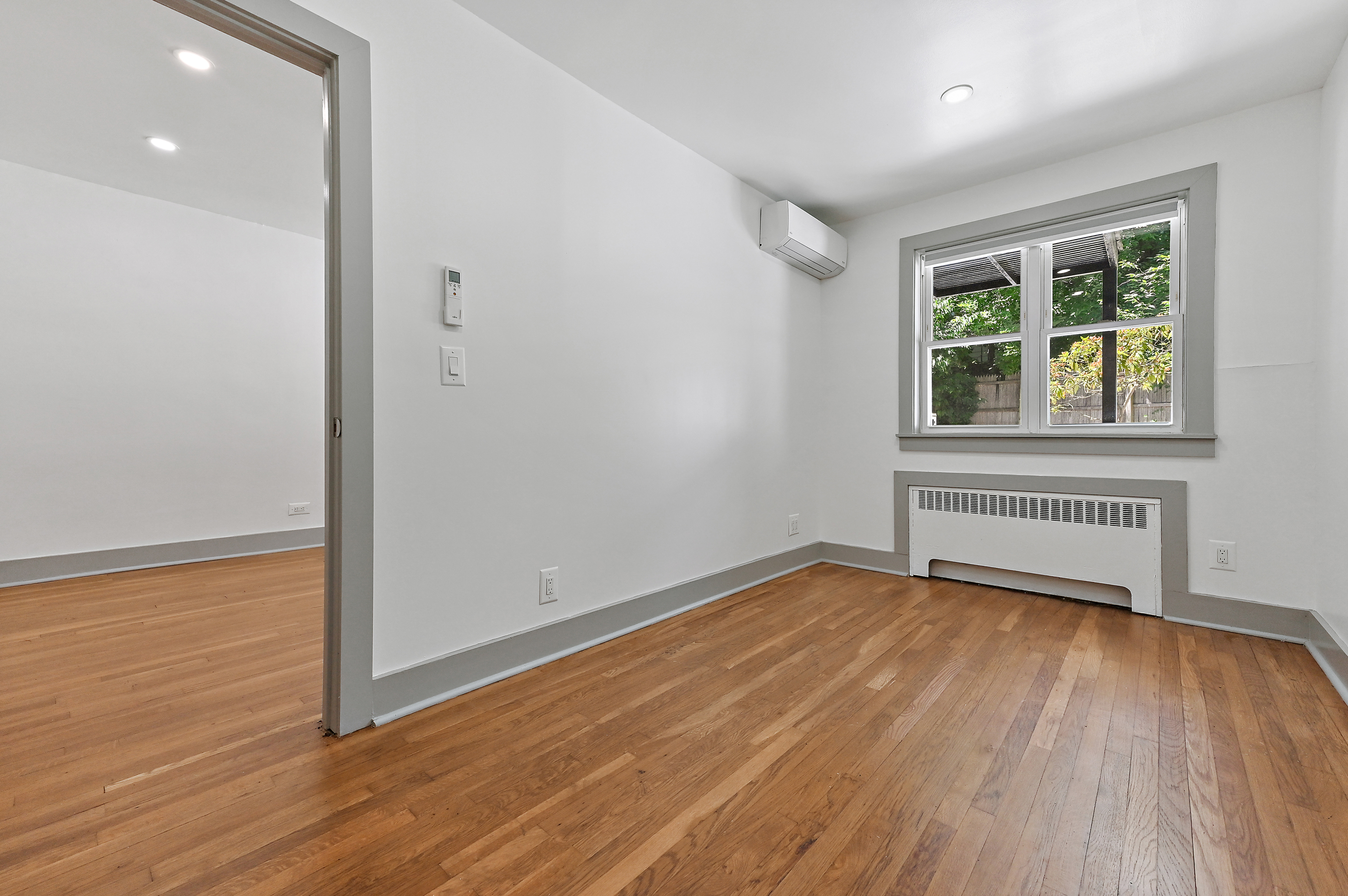 5823 Fieldston Road, Unit 1A Bronx, NY 10471 - Photo 10 of 26 a view of an empty room with wooden floor and a window