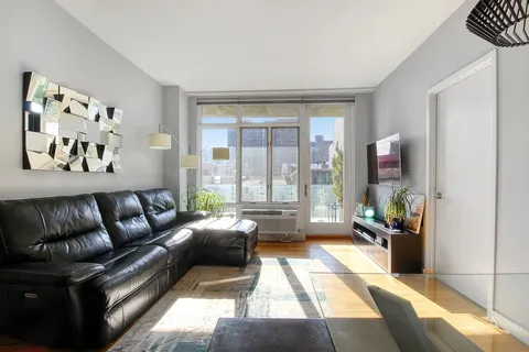 a living room with furniture and a large window