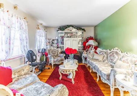 a very nice looking bedroom with a large bed couch and a chandelier