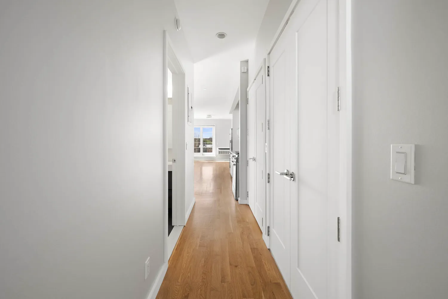 a view of a room with wooden floor and a window