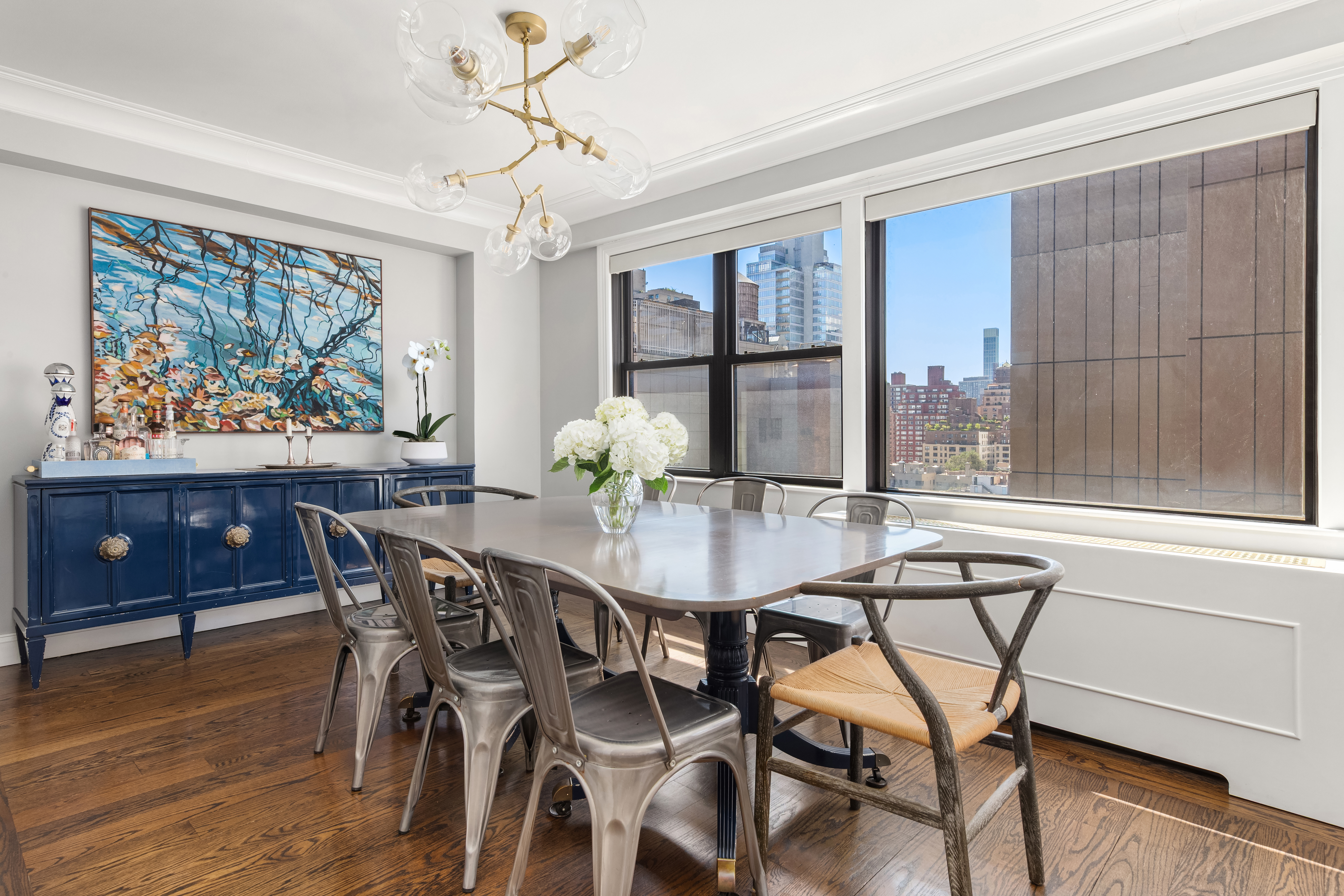 201 East 77th Street, Unit 14AF Manhattan, NY 10075 - Photo 3 of 13 a view of a dining room with furniture window and wooden floor