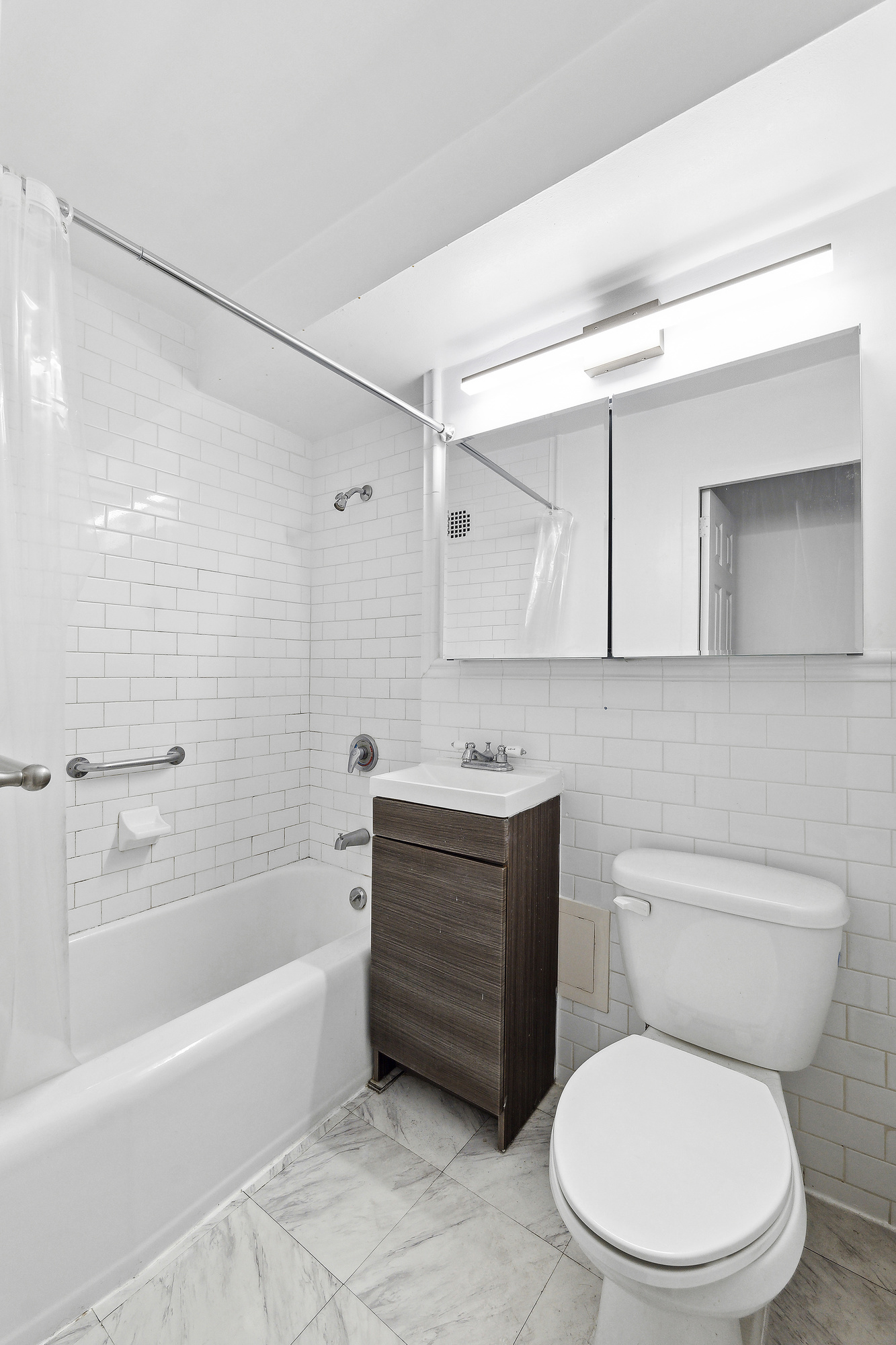 110 East 36th Street, Unit 5B Manhattan, NY 10016 - Photo 4 of 7 a bathroom with a toilet a sink and bathtub