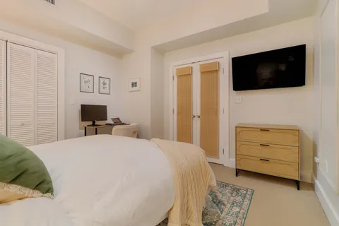 a bedroom with a bed and a flat screen tv