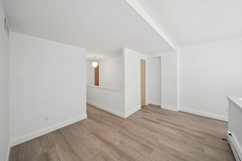 65 Cooper Square, Unit 2A Manhattan, NY 10003 - Photo 8 of 13 an empty room with wooden floor and windows