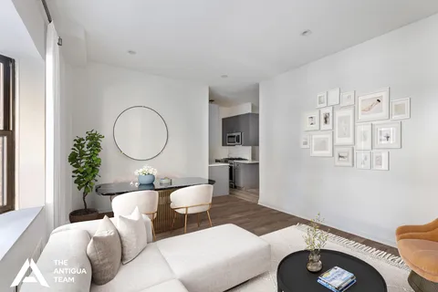 a living room with furniture a mirror and a toilet