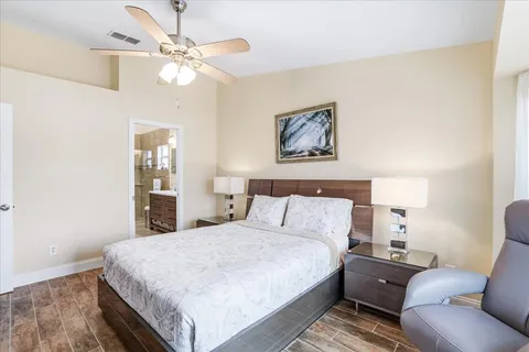 a bedroom with a large bed and a chandelier