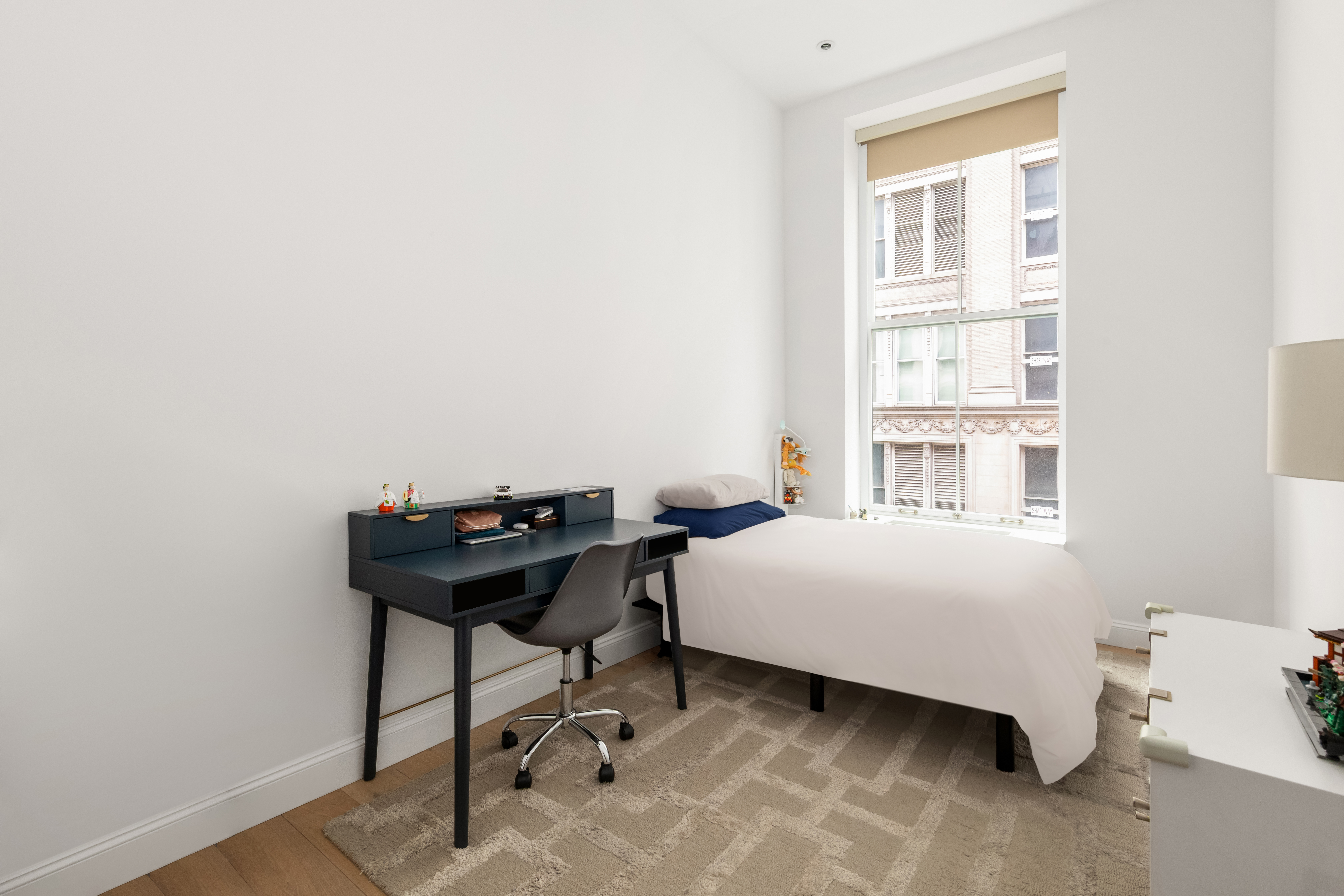 655 6th Avenue, Unit 5H Manhattan, NY 10010 - Photo 9 of 15 a bedroom with a bed and a window