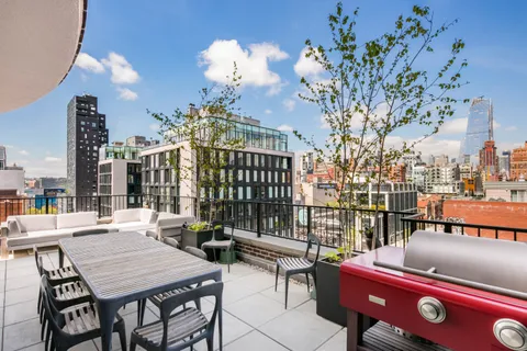 a view of a patio with couches table and chairs and potted plants