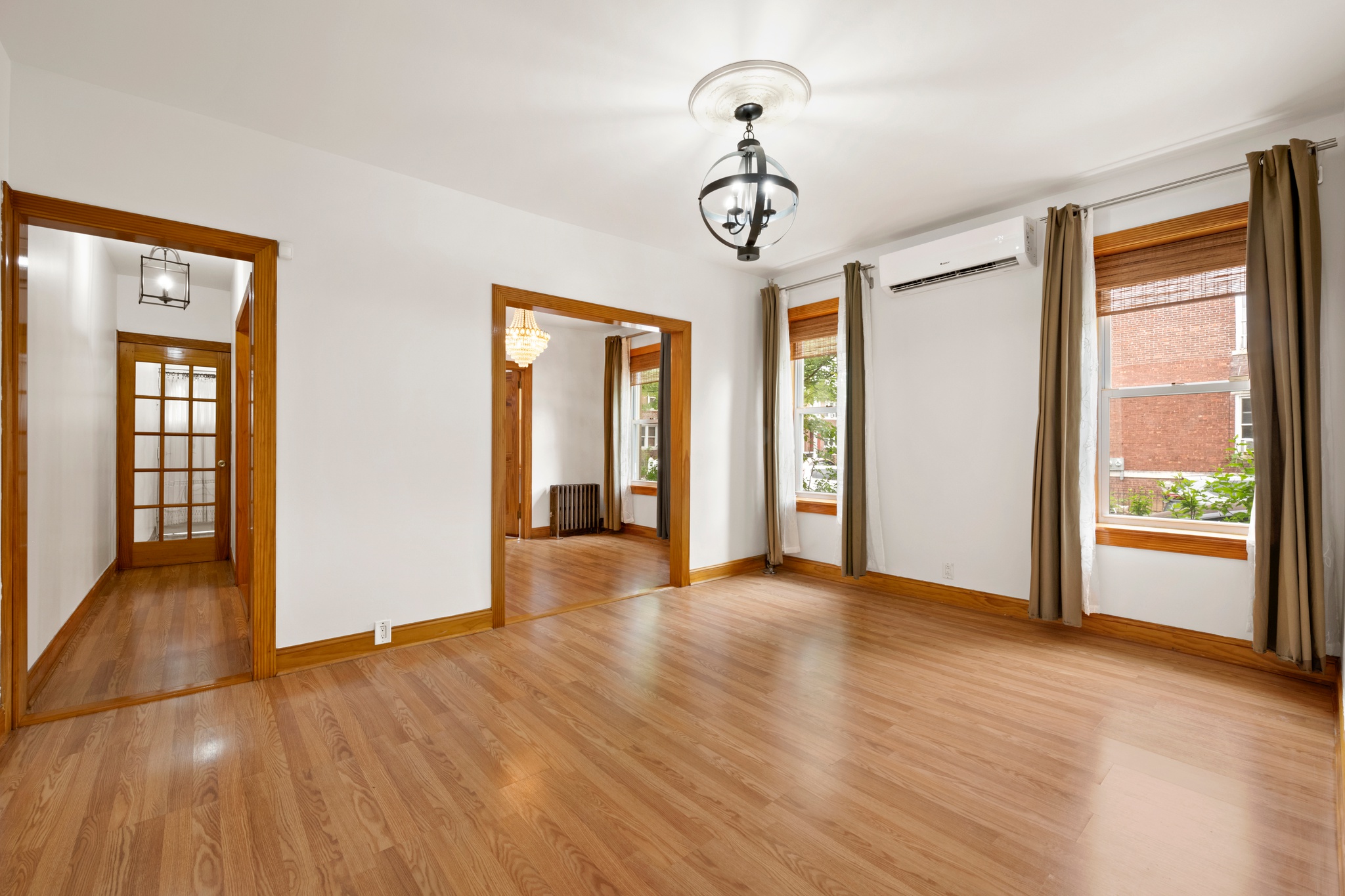 95 Chester Avenue, Unit 1 Brooklyn, NY 11218 - Photo 2 of 13 a view of empty room with wooden floor and fan