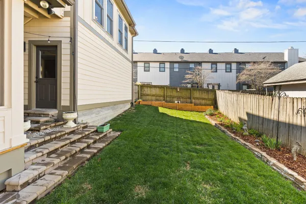a view of a house with wooden fence