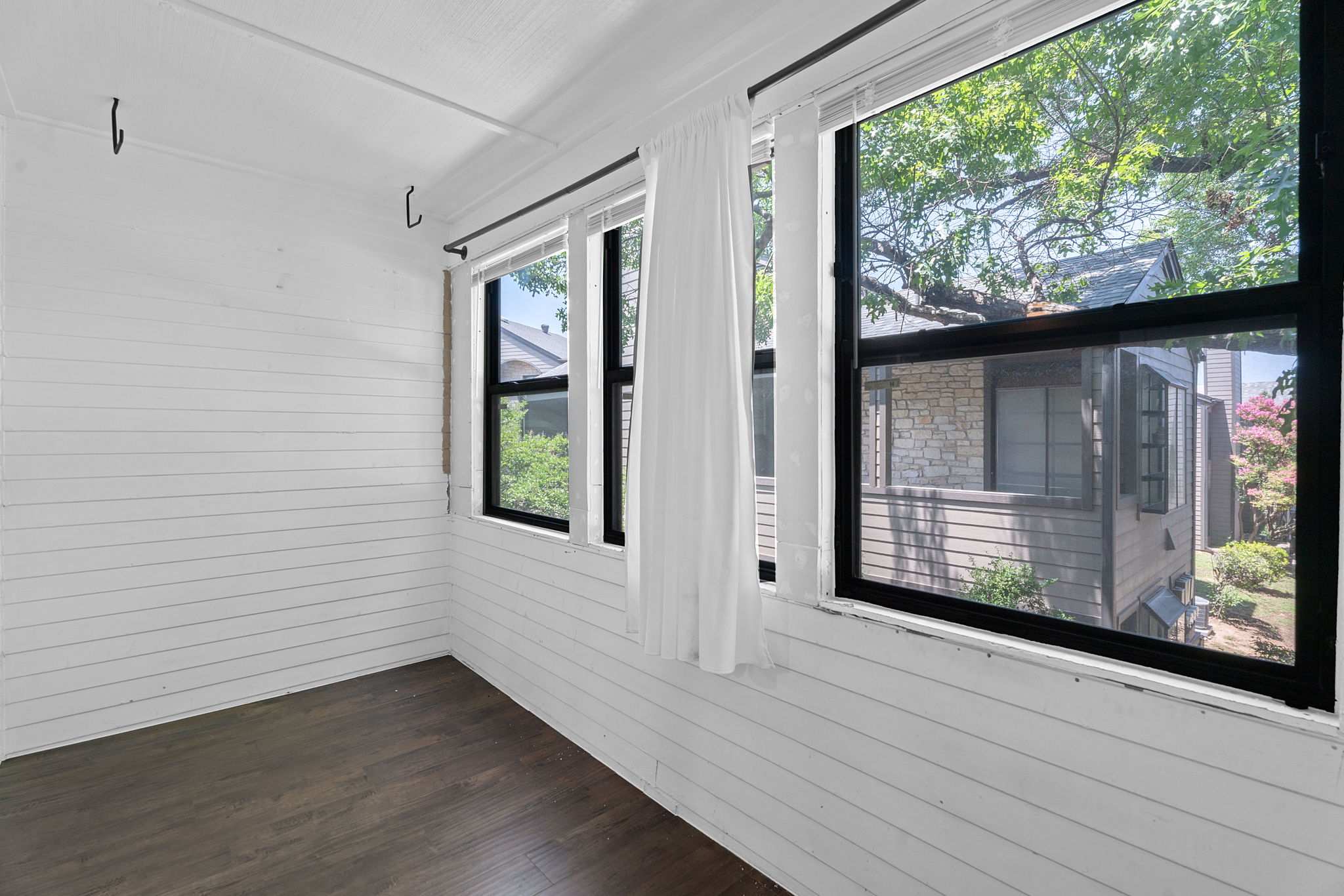 1510 West N Loop Boulevard, Unit 424 Austin, TX 78756 - Photo 17 of 25 a view of an empty room with wooden floor and a window