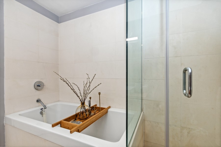119 Fulton Street, Unit 2B Manhattan, NY 10038 - Photo 9 of 10 a bathroom with a tub and a shower