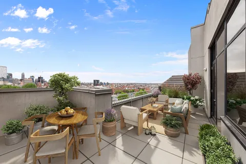 a terrace with outdoor seating and city view