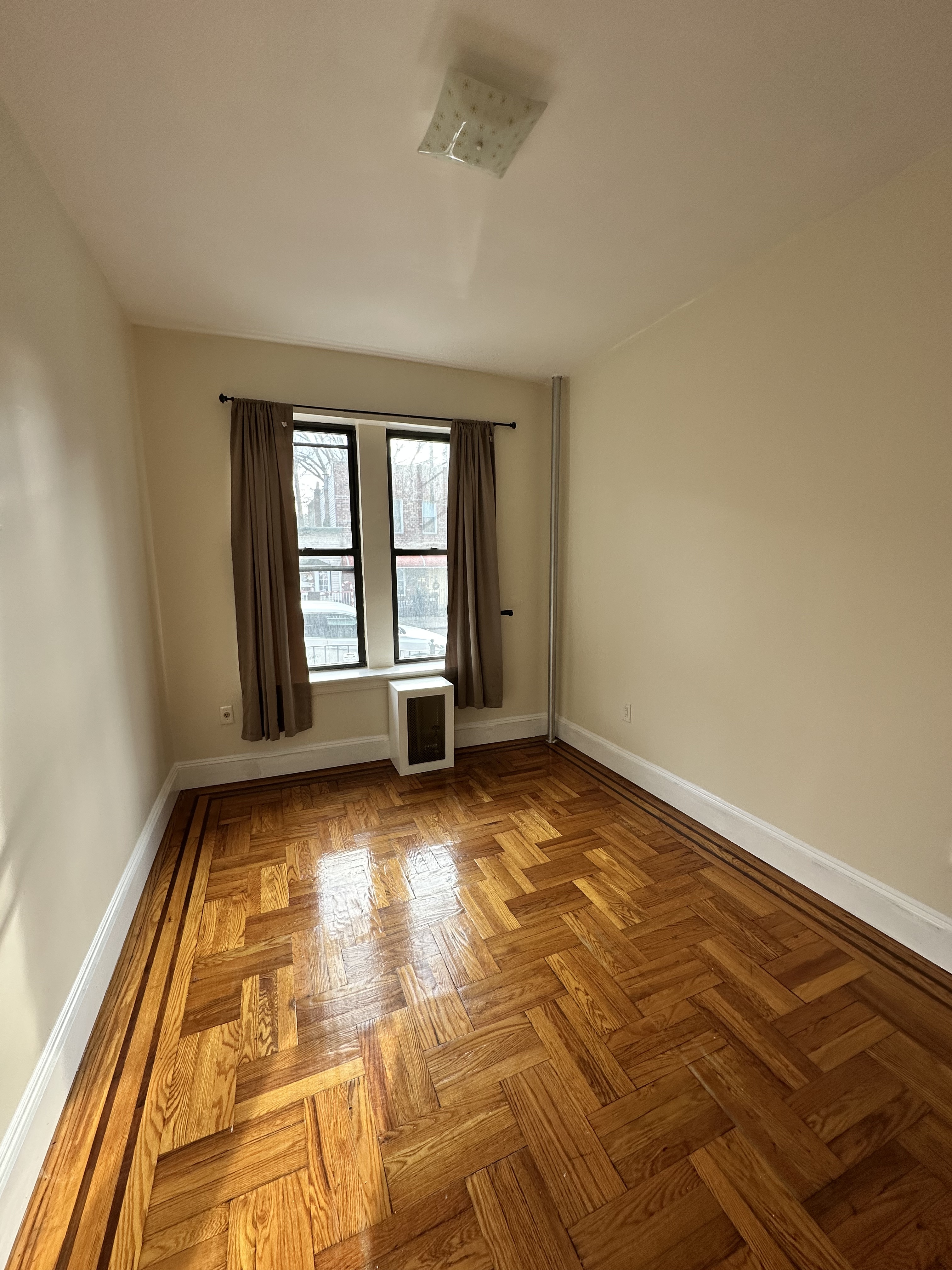31-40 42nd Street, Unit 1F Queens, NY 11103 - Photo 5 of 9 a view of an empty room and window