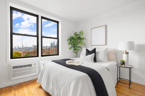 a bedroom with a large bed and a large window