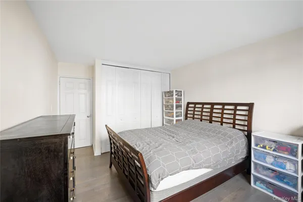 a bedroom with a bed and a dresser in it