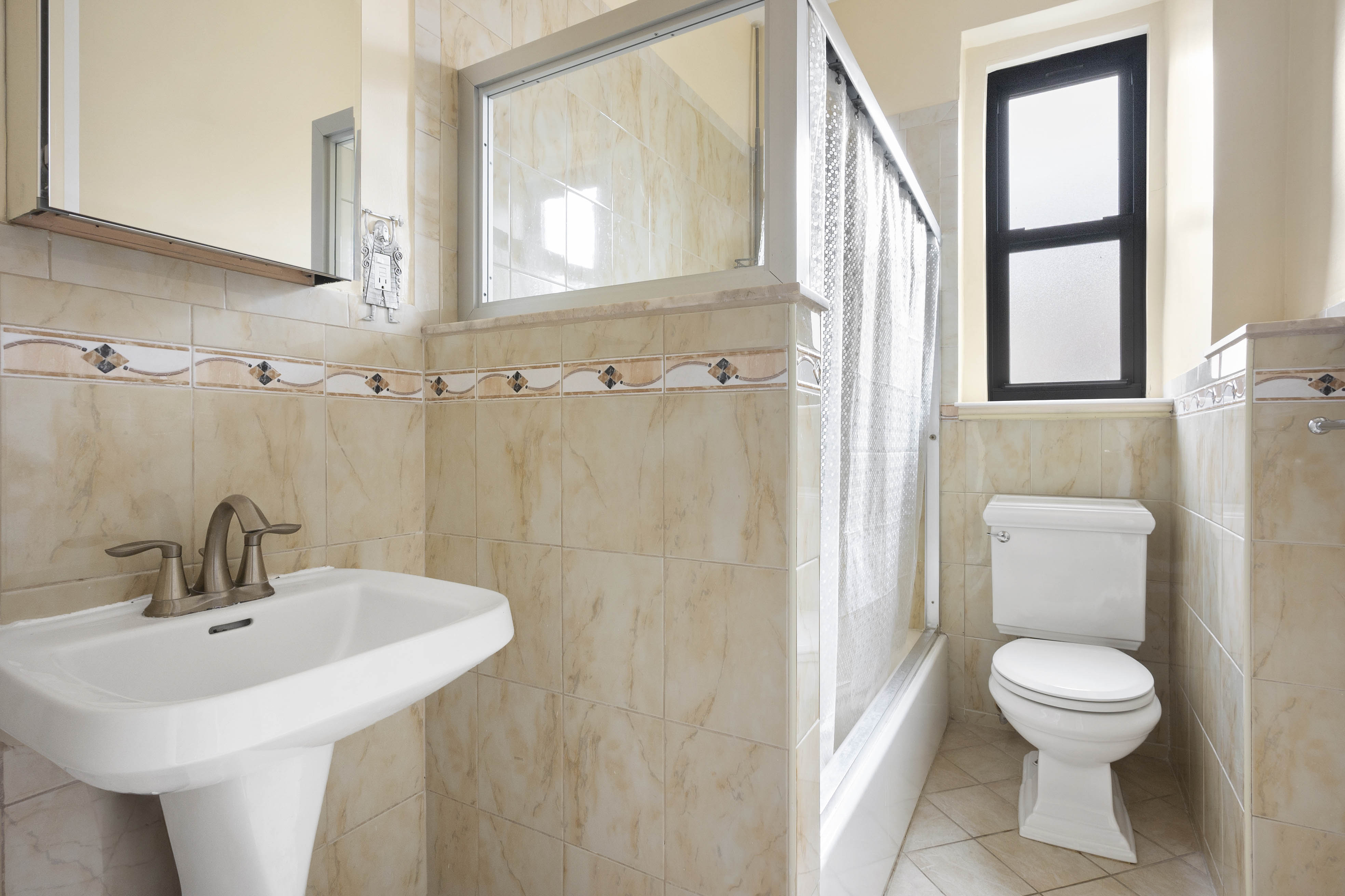 371 Fort Washington Avenue, Unit 6C Manhattan, NY 10033 - Photo 6 of 11 a bathroom with a sink a toilet and a mirror