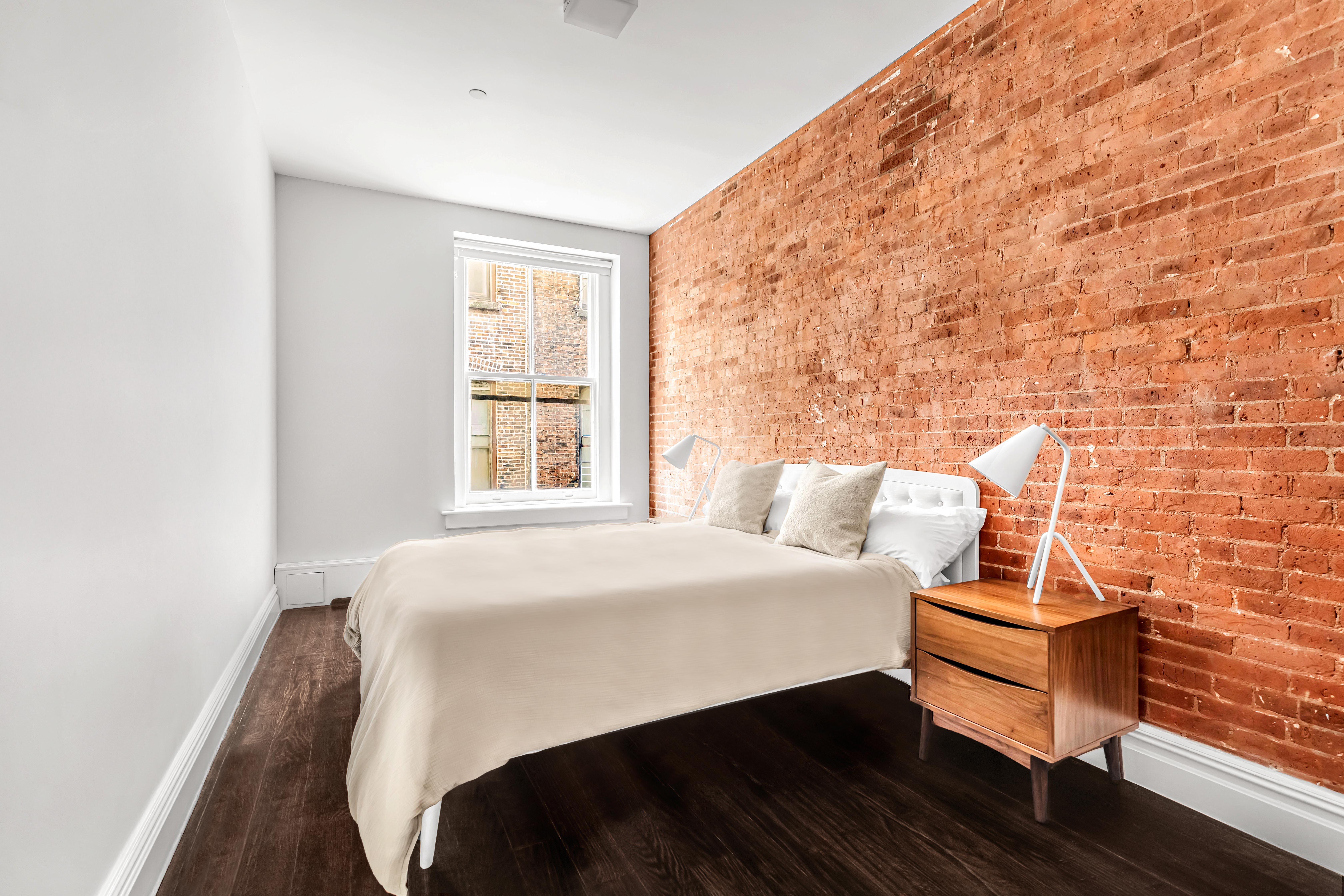 175 Franklin Street, Unit 4 Manhattan, NY 10013 - Photo 7 of 13 a bedroom with a bed and window