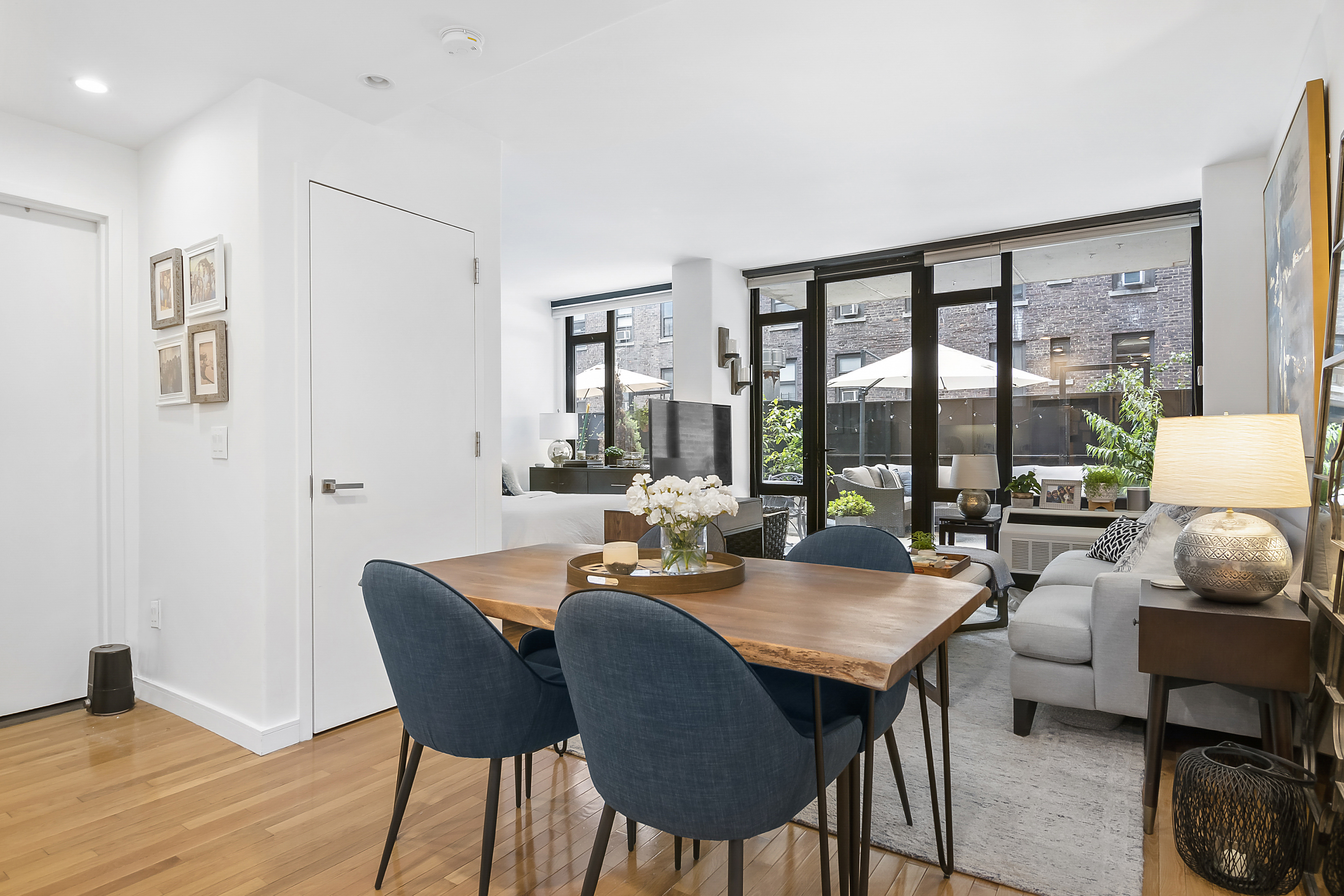 148 East 24th Street, Unit 3F Manhattan, NY 10010 - Photo 1 of 9 a dining room with furniture a rug and a floor to ceiling window