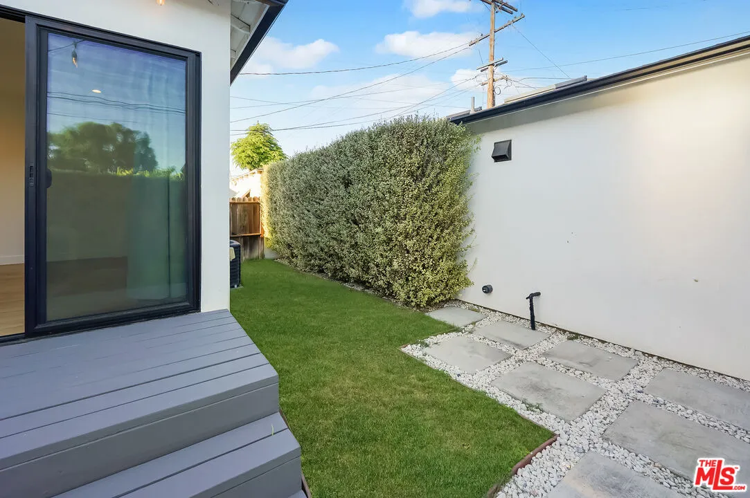 a potted plant sitting on a wooden floor next to a yard