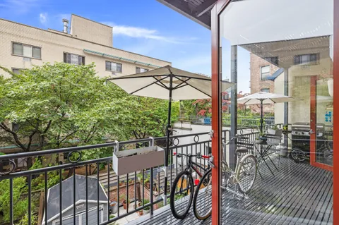 a view of a balcony with chairs and wooden floor