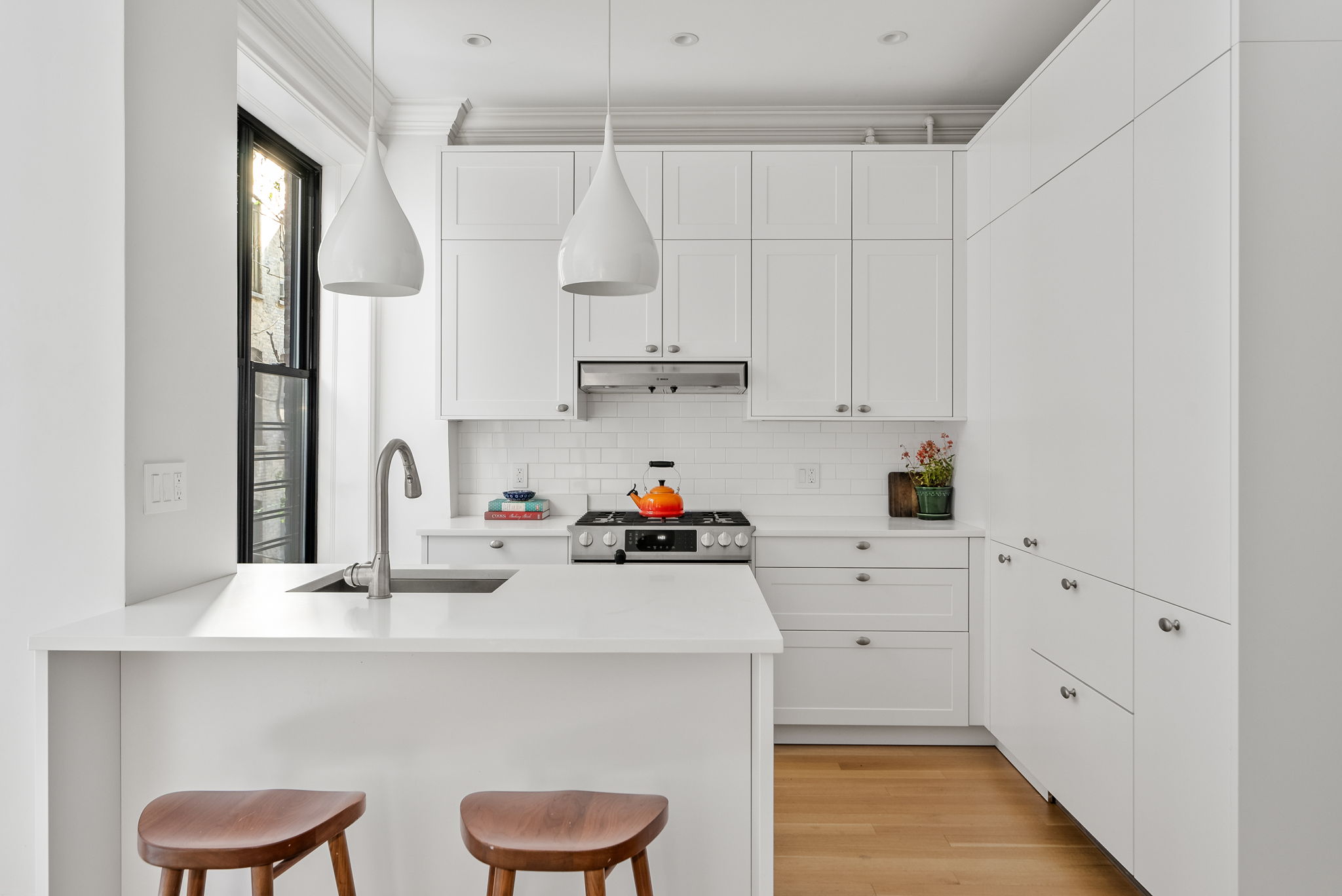 210 Riverside Drive, Unit 2E Manhattan, NY 10025 - Photo 3 of 15 a kitchen with white cabinets and white appliances