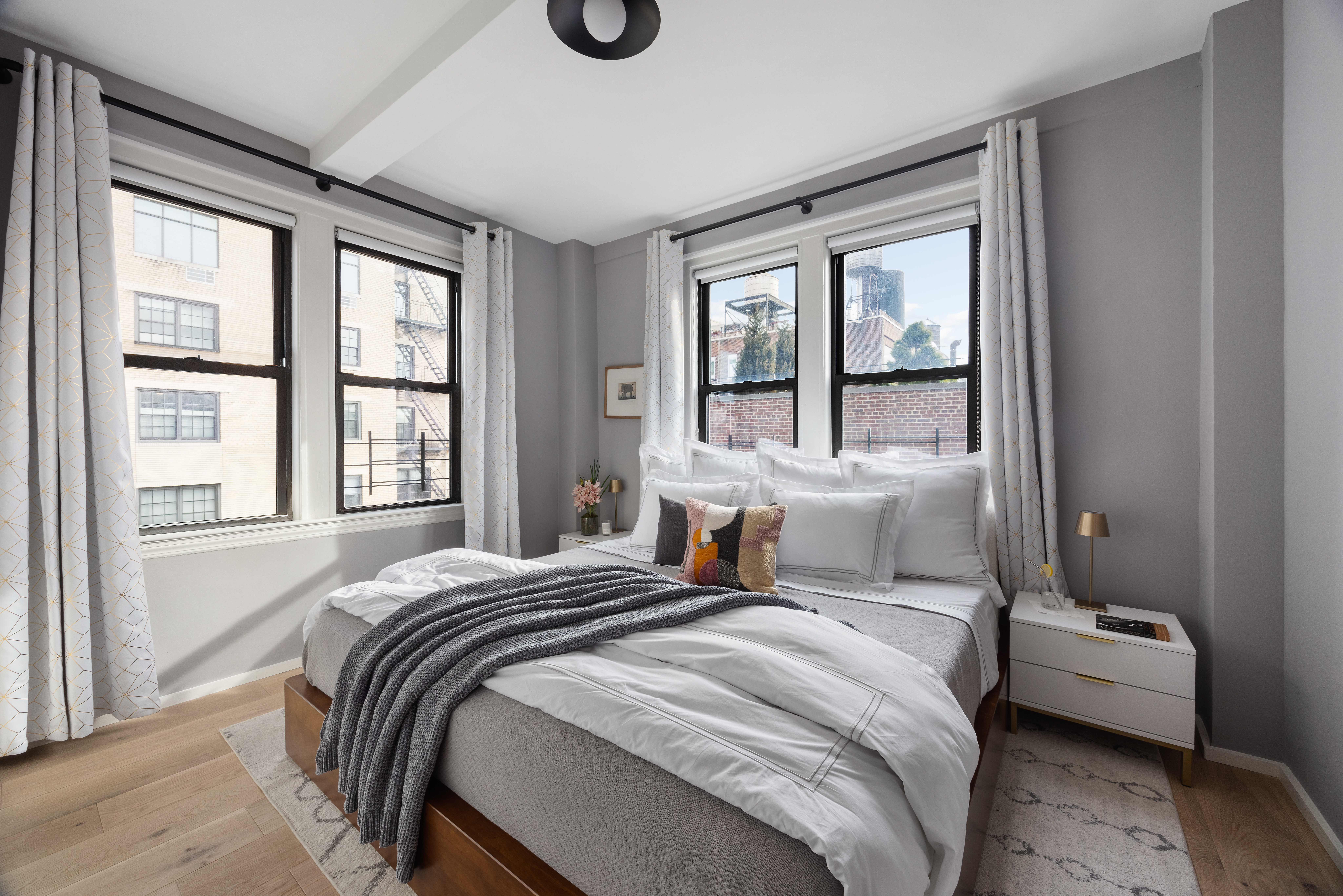 45 5th Avenue, Unit 15CD Manhattan, NY 10003 - Photo 7 of 14 a bedroom with a bed and a large window