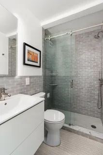 a bathroom with a toilet sink and shower
